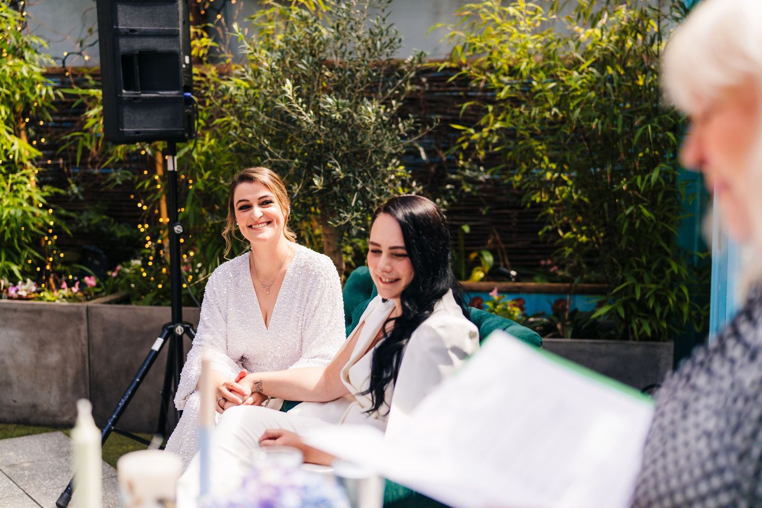 People conversing at an outdoor garden table during a special event. House Dublin Wedding Photographer