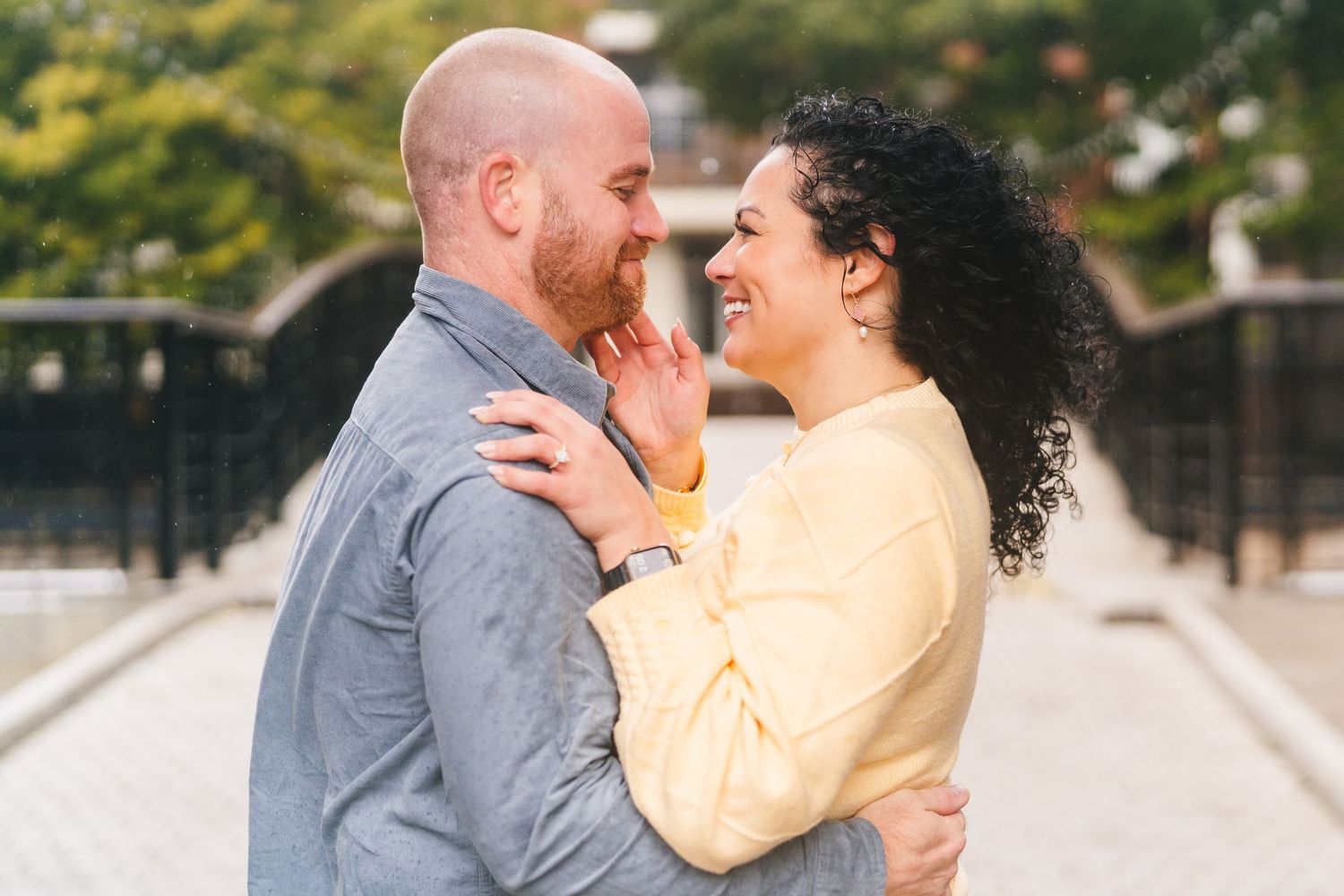 A couple shares an intimate romantic moment outdoors in the gardens during their wedding photo session.