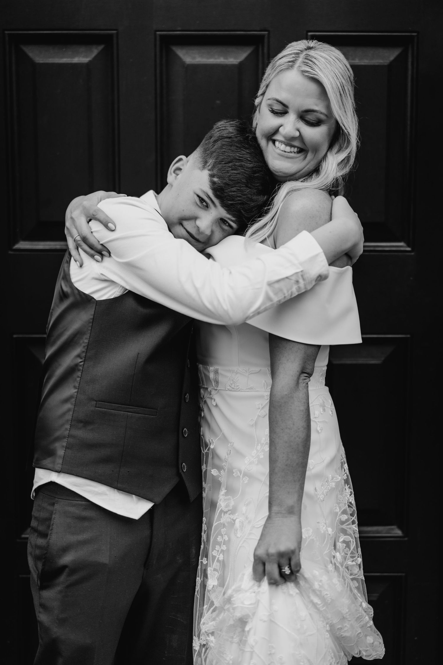 Black and white portrait of a tender embrace between a couple in formal wedding attire. The Dean Dublin Wedding Photographer