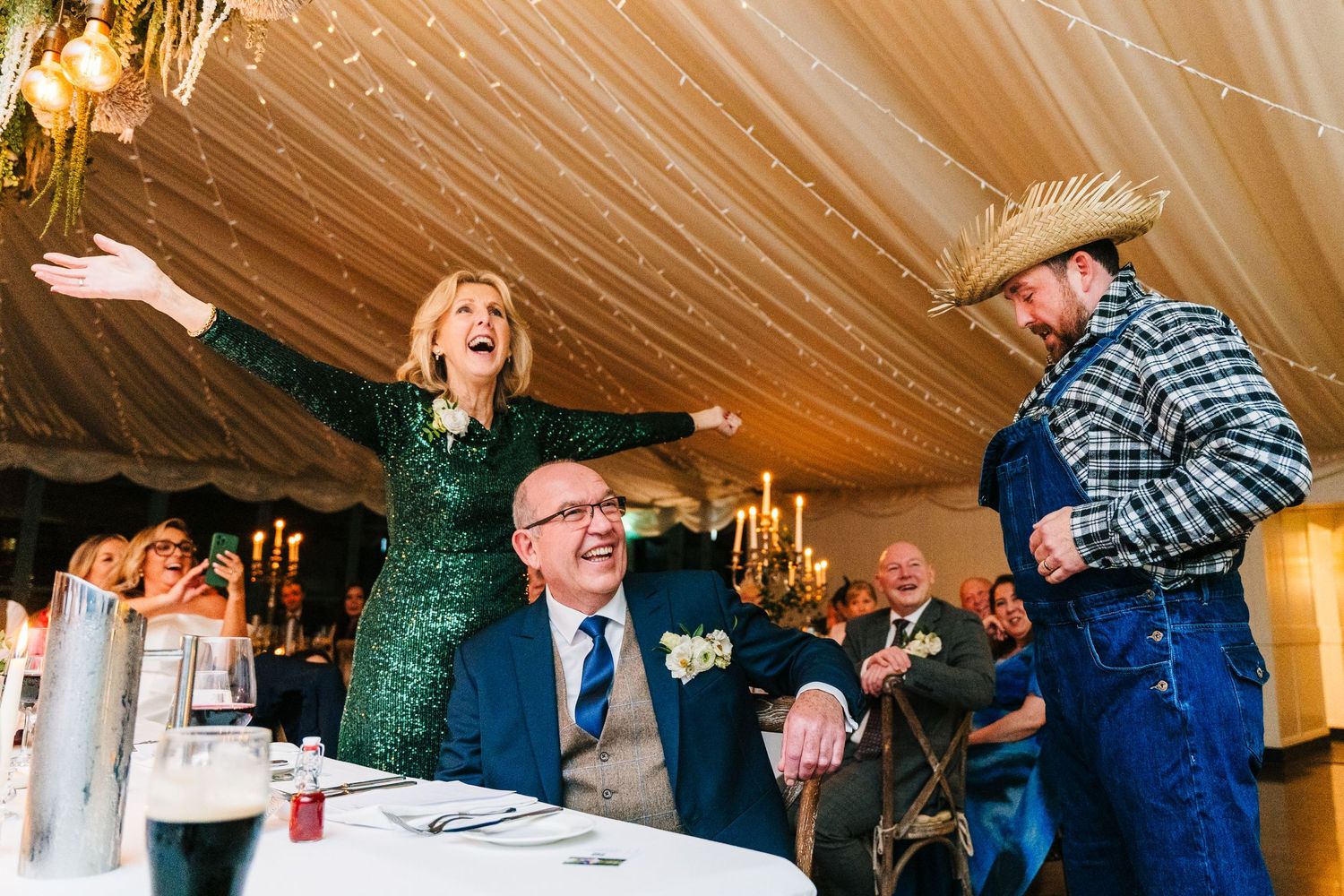 Wedding guests dancing and celebrating under draped fabric ceiling with warm lighting.  Virginia Park Lodge Wedding Photographer Cavan Dubli