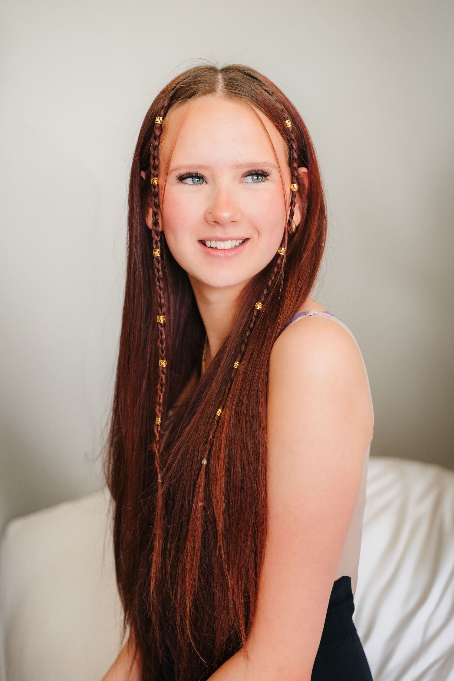 Portrait photo with golden accents and hair decorations in a delicate indoor setting. Portmarnock Hotel Wedding PHOTOGRAPHER Dublin