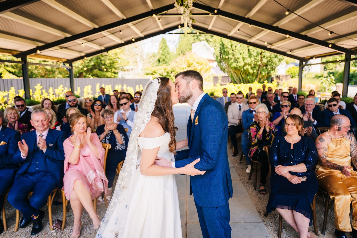 Poulaphouca Wedding photographer wicklow  Wedding reception guests dancing and celebrating together under a covered outdoor venue.