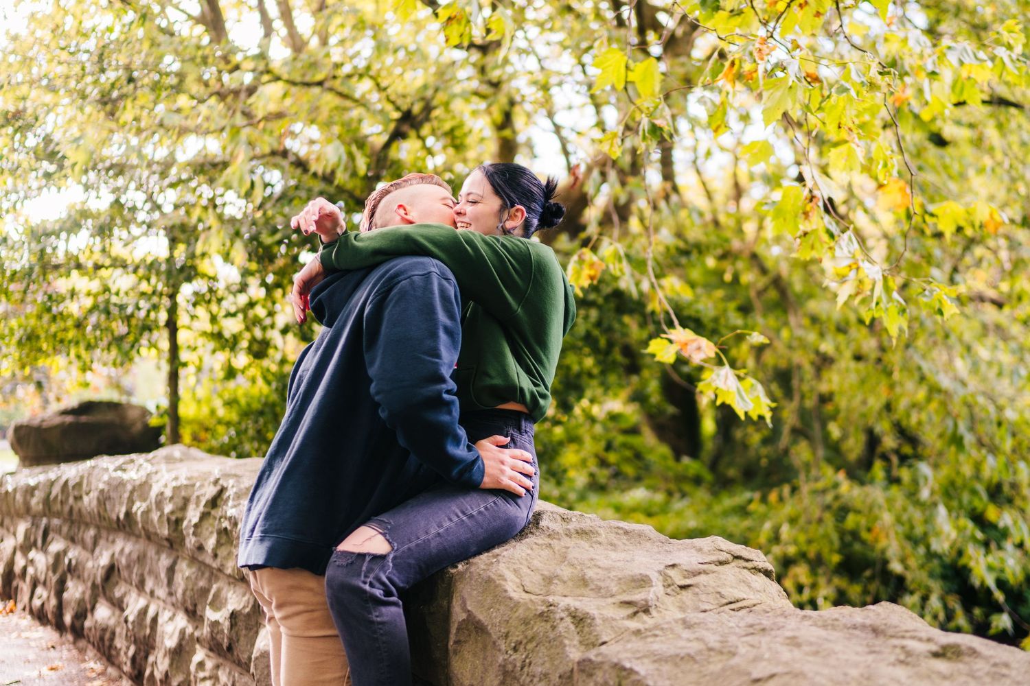 Autumn scene with couple sharing intimate moment on stone wall. PHOTOGRAPHER Dublin Ireland