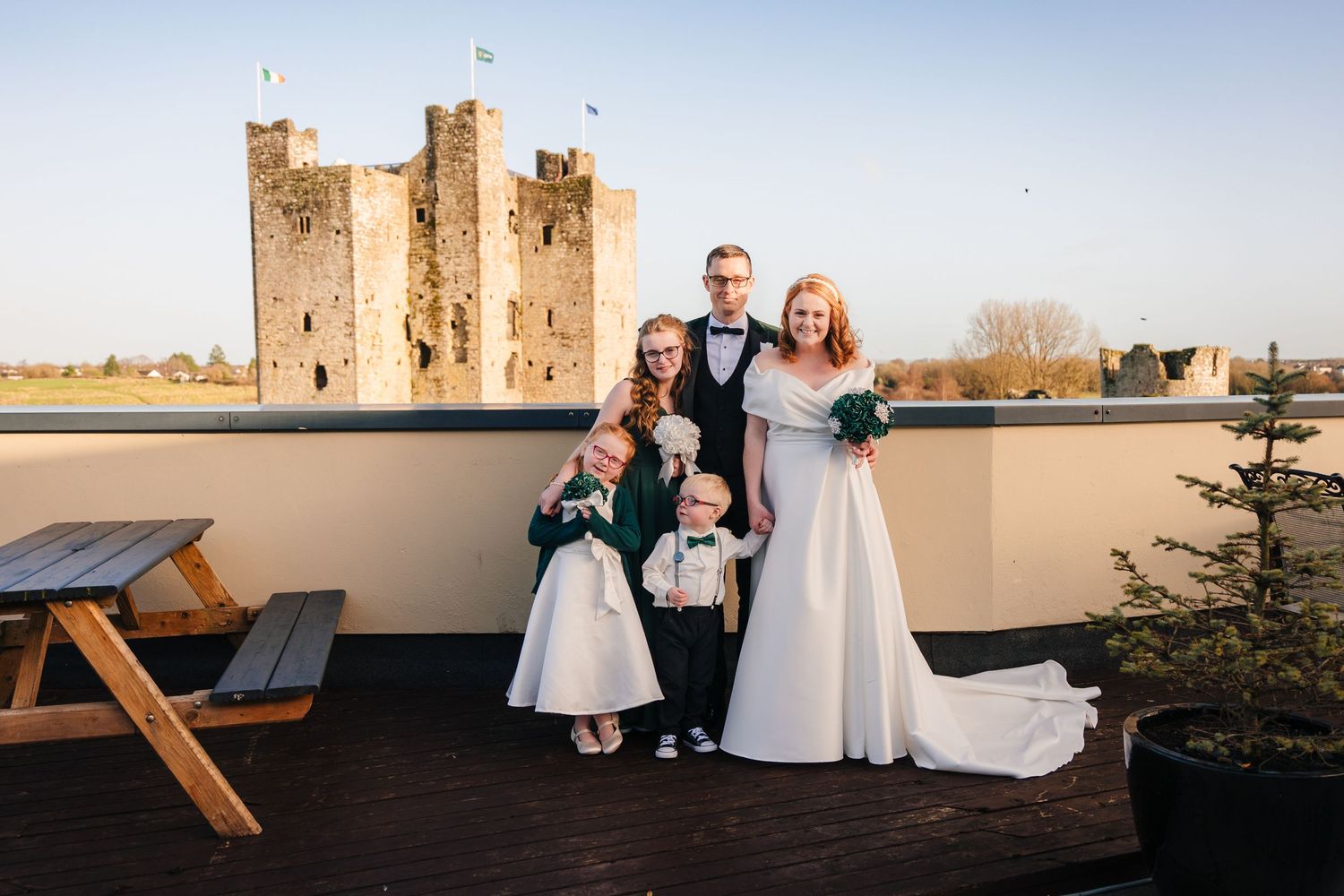Castle wedding venue at sunset with guests seated during an outdoor ceremony.  Wedding PHOTOGRAPHER Trim Castle