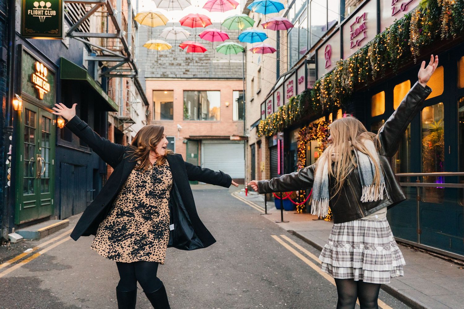 Colorful street with hanging umbrellas and historic buildings in Dublin's city center. family PHOTOGRAPHER Dublin
