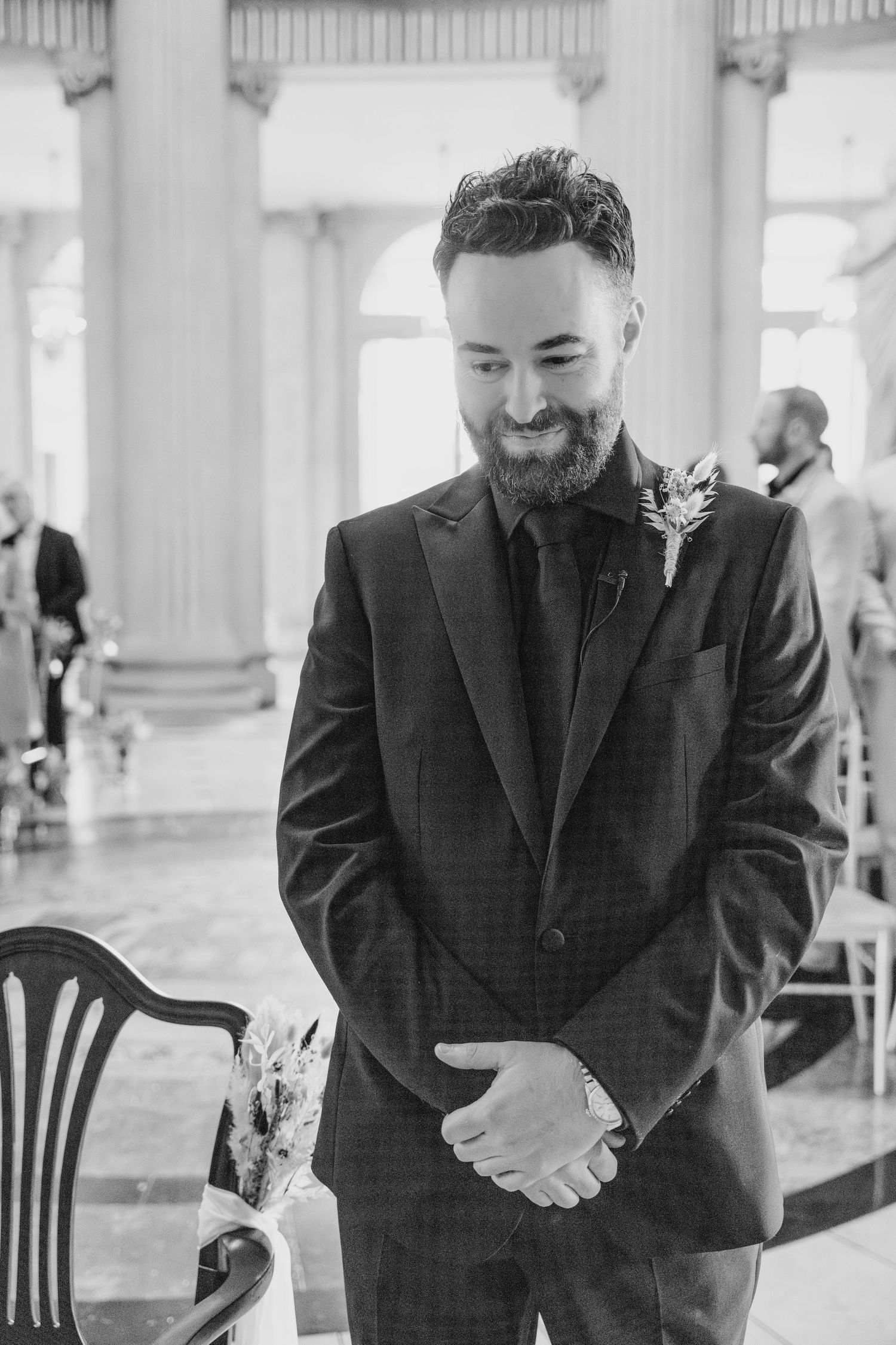Black and white sequence of candid reactions showing joyful laughter between people in formal attire.  city hall dublin wedding photos