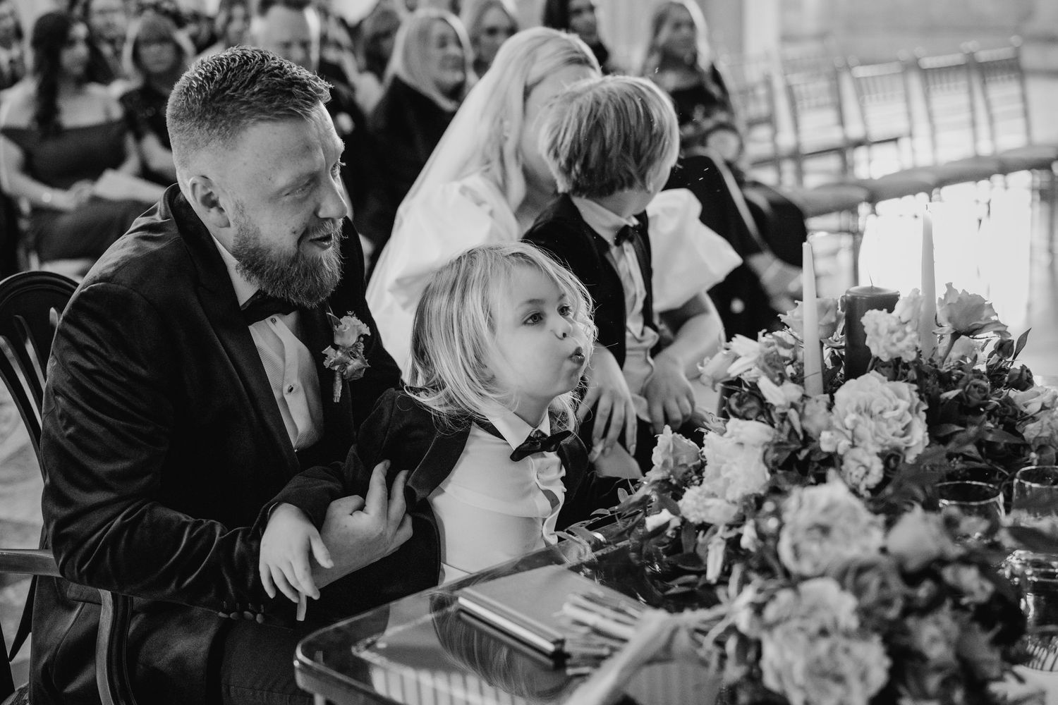 Black and white candid wedding reception photos showing guests laughing and enjoying themselves. Wedding photographer dublin