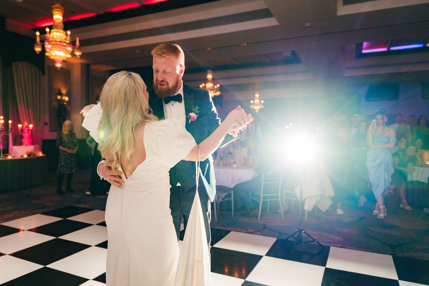 Dance floor at wedding reception with dramatic lighting and checkered floor pattern. Wedding photographer dublin