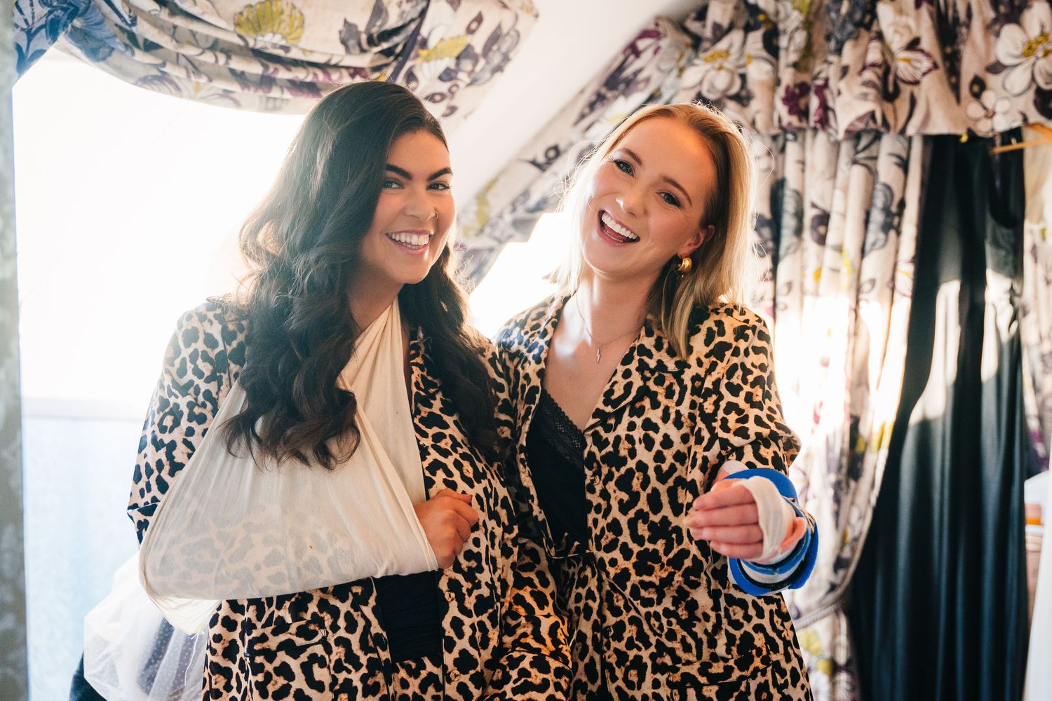 Wedding party members in leopard print and dark attire sharing joyful moments together. Wedding photographer dublin