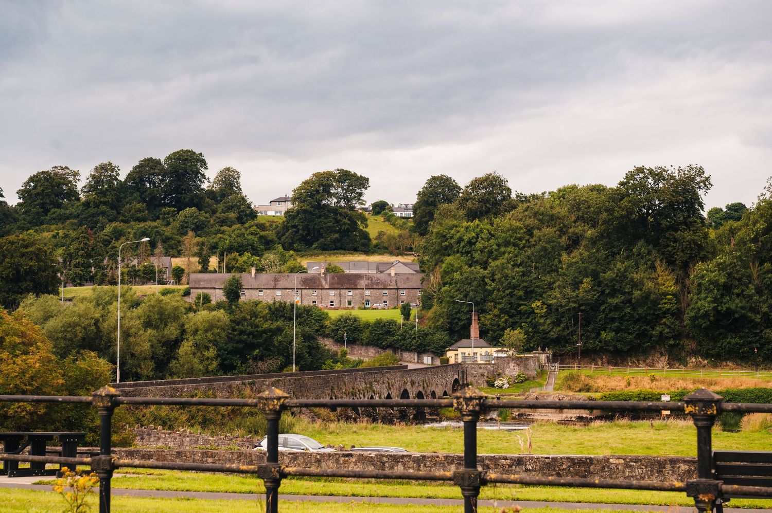 Millhouse slane wedding photographer dublin Rural countryside landscape with stone buildings and fences nestled among green hills and trees.