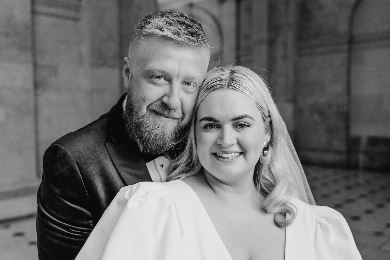 Wedding couple shares intimate moments in classic black and white portraits at a historic stone building. City Hall Dublin Photographer