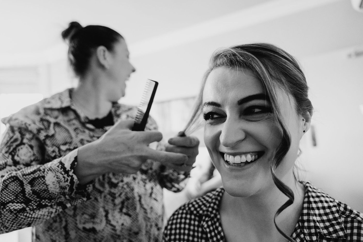 Wedding party preparations with joyful moments captured in black and white photography. House Dublin Wedding Photographer