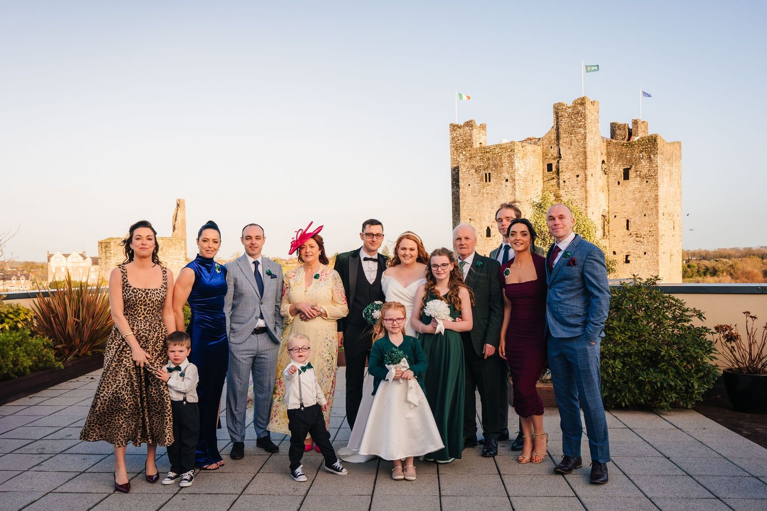 Panoramic sequence showing a bridal party posing outside a historic stone castle during sunset.  Wedding PHOTOGRAPHER Trim Castle