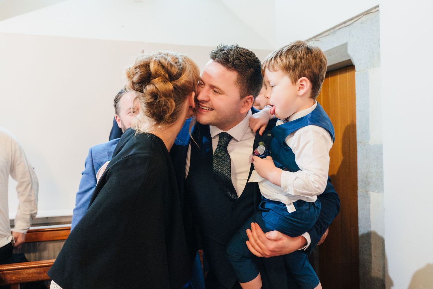Candid moments of wedding guests embracing and interacting during reception.