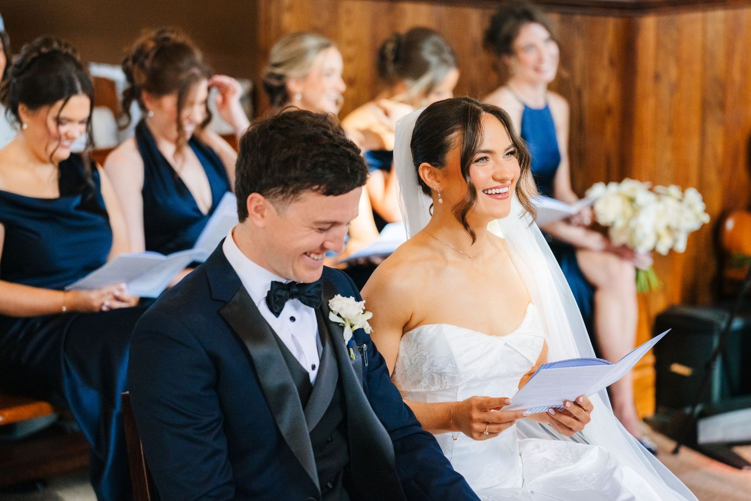 Wedding guests enjoying a lively celebration in a rustic wooden venue with warm lighting. Virginia Park Lodge Wedding photographer Dublin