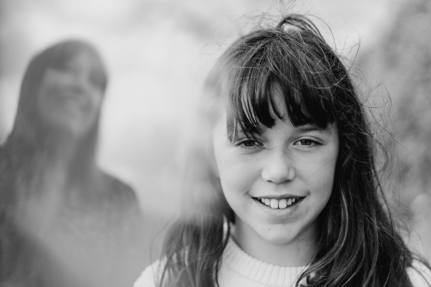 A collection of black and white headshot portraits showing smiling expressions arranged in a row. family PHOTOGRAPHER Dublin