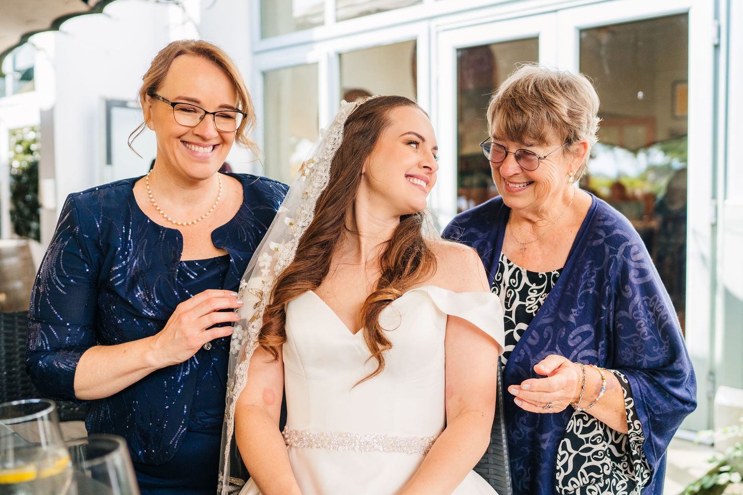 Poulaphouca Wedding photographer wicklow  Three women share a joyful moment together during a wedding celebration.