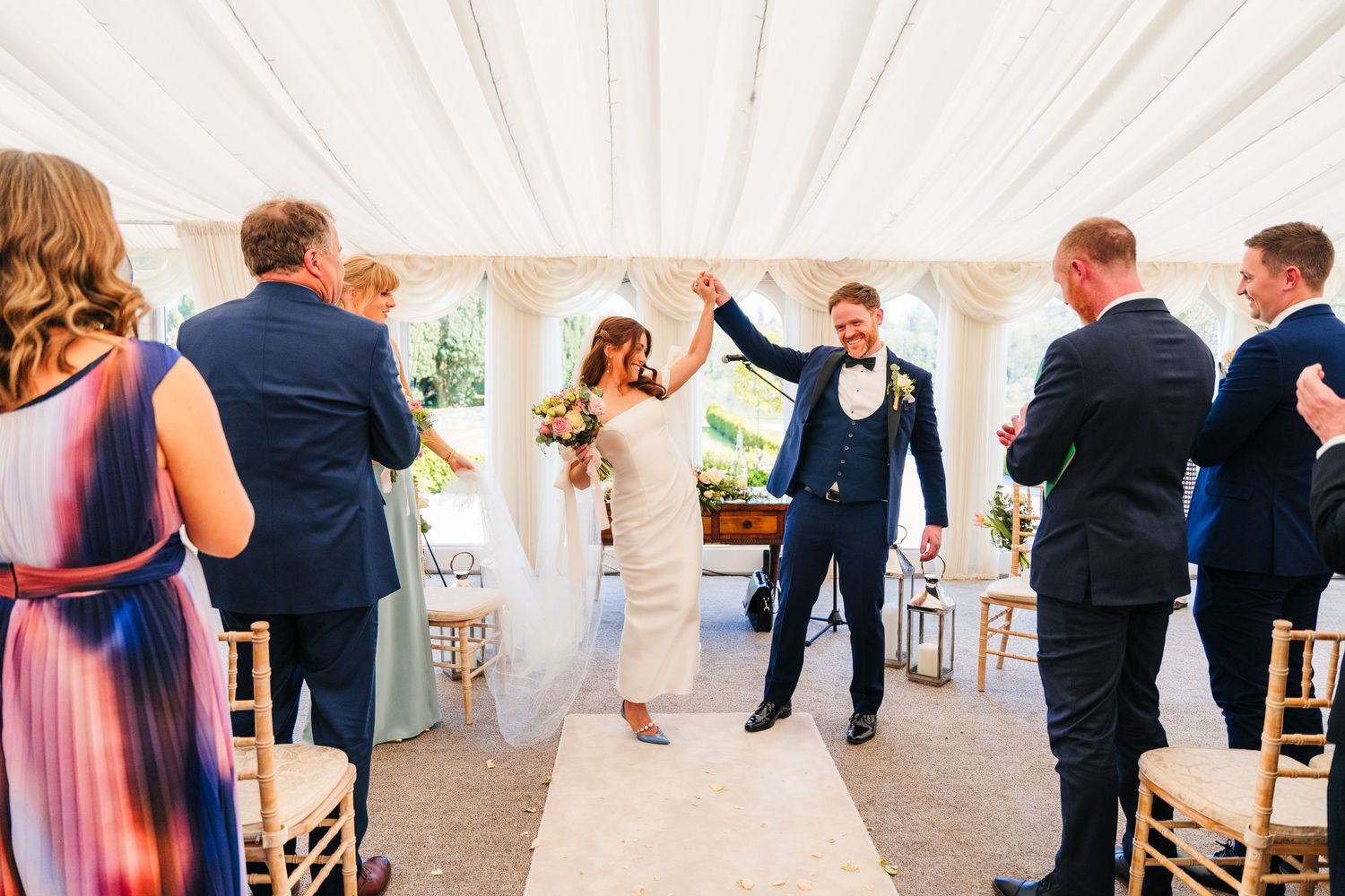 Castle Leslie Wedding Photographer DWedding guests celebrate and dance together during a lively reception in an elegant white marquee tent.