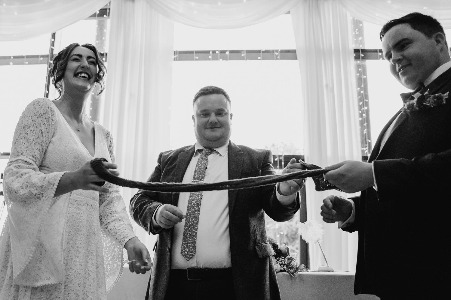 Four sequential black and white wedding photos show joyful celebratory moments during a reception. Wedding Photography Trim Castle Ireland