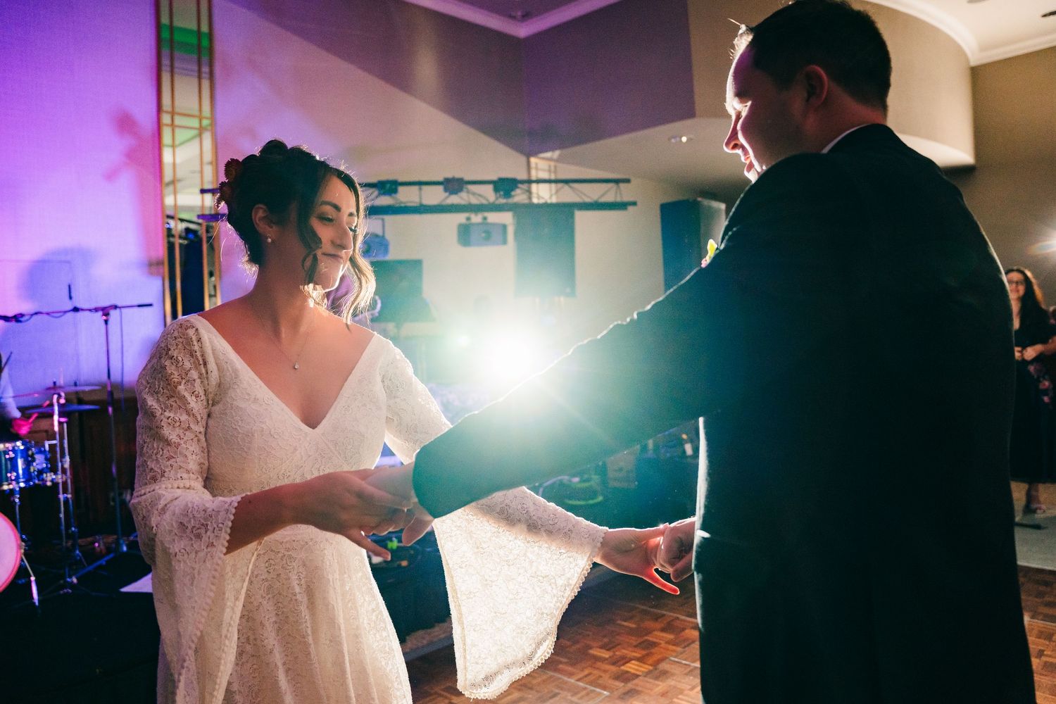 Wedding guests dancing in a purple-lit reception venue with dramatic lighting effects.Wedding Photography Trim Castle Ireland