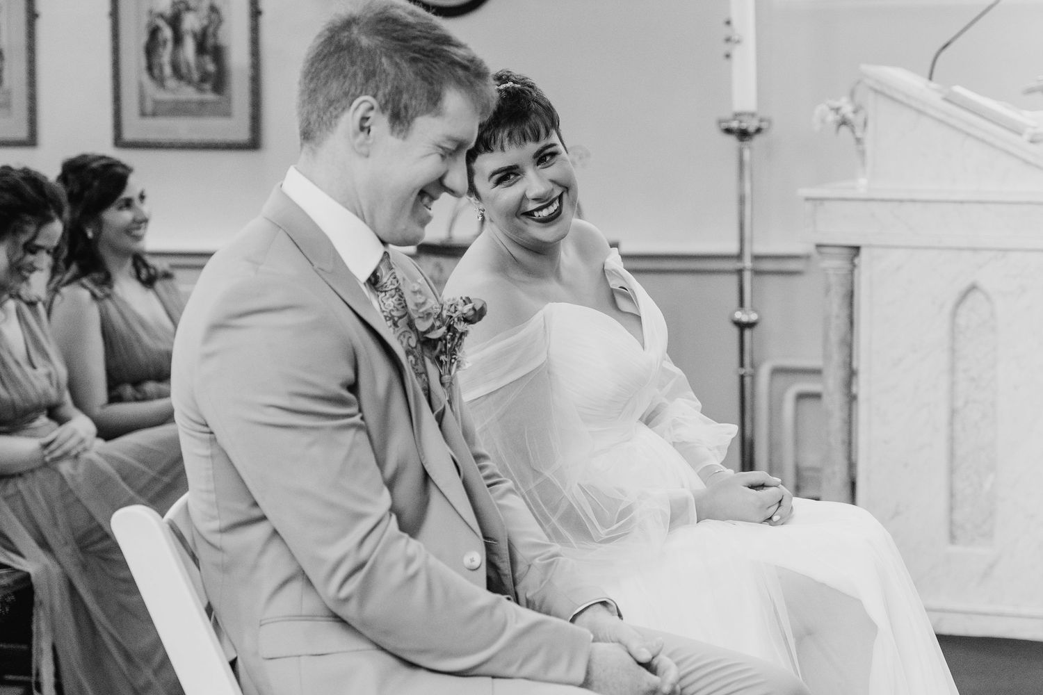 Millhouse slane wedding photographer dublin Black and white photo of joyful moment during church wedding ceremony.