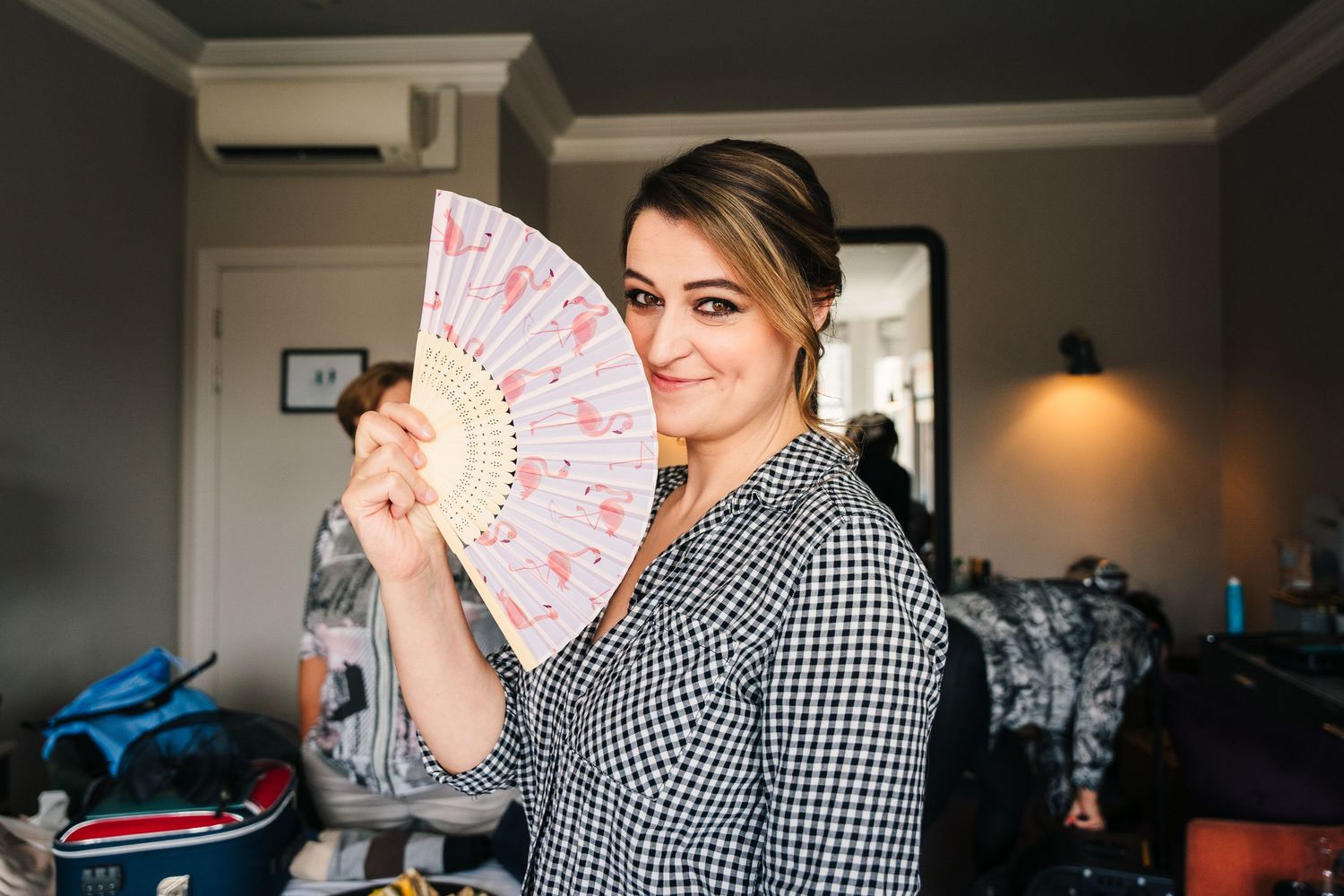 A sequence of photos showing people laughing and fanning themselves with decorative paper fans. House Dublin Wedding Photographer