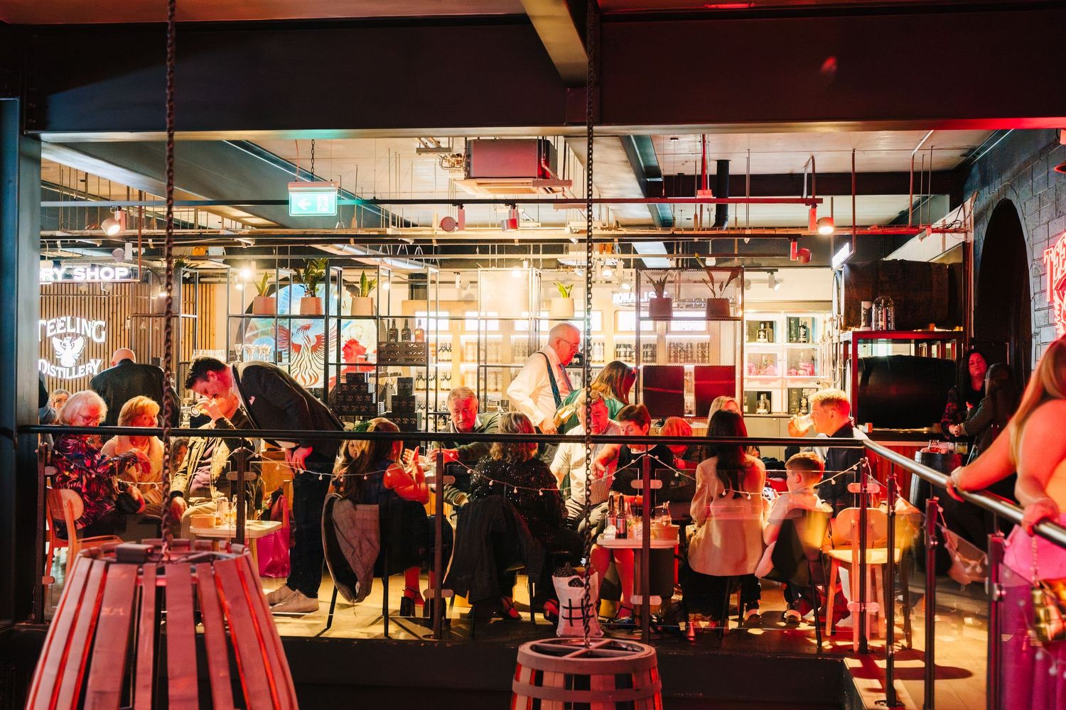 Red-tinted view of a modern gym interior with exercise equipment and workout stations. Dublin wedding photogrAPher