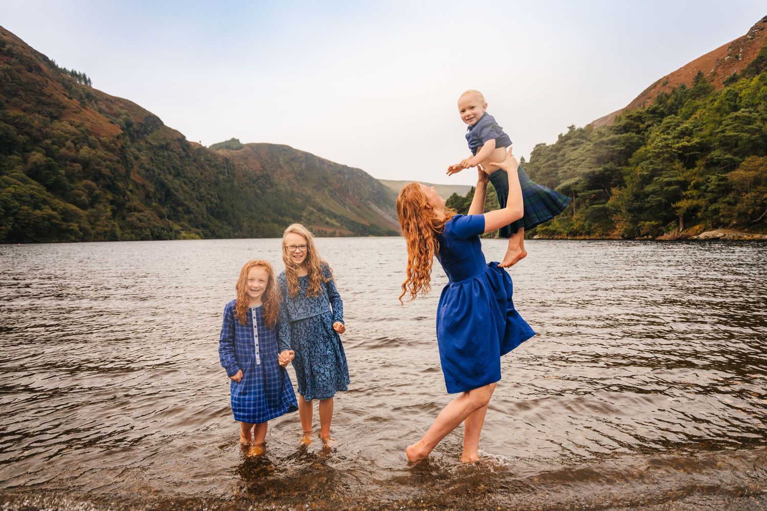 Joyful family playing together in the water at a scenic mountain lake.Family photogrAPHER DUBLIN