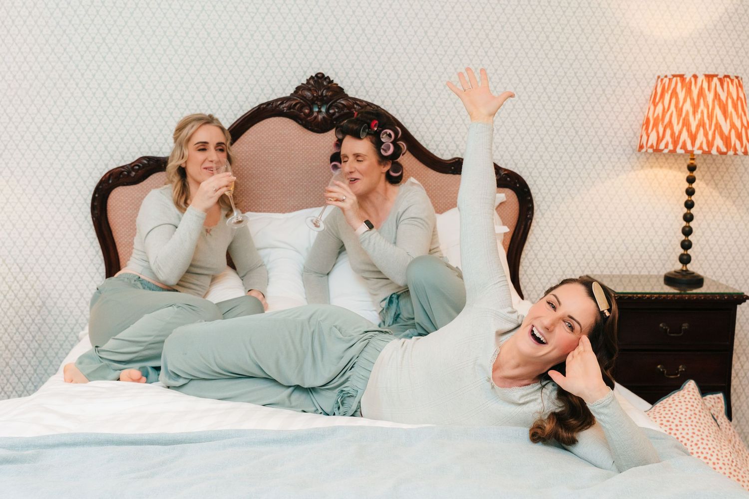 Couple lying in bed together sharing intimate moments in a romantic bedroom setting.