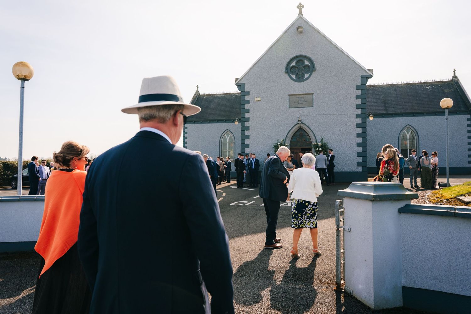 Wedding ceremony taking place in a traditional white church with stone walls and cross on top. Virginia Park Lodge Wedding photographer