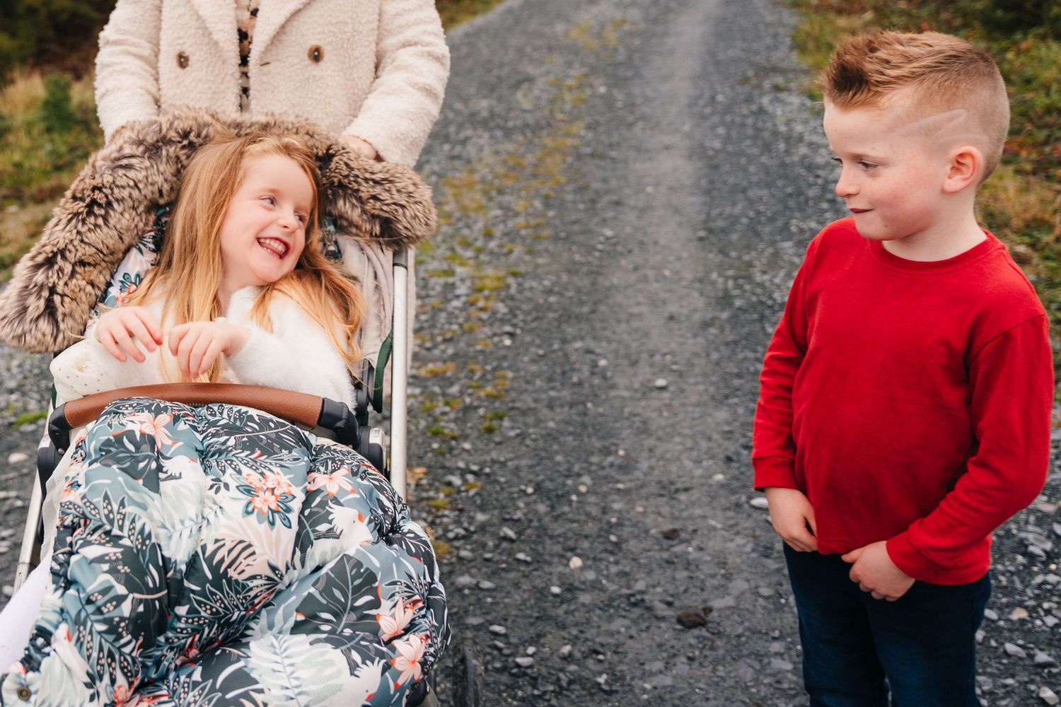 Family Photographer Dublin Ireland Casual outdoor family photos on a gravel path surrounded by autumn scenery.