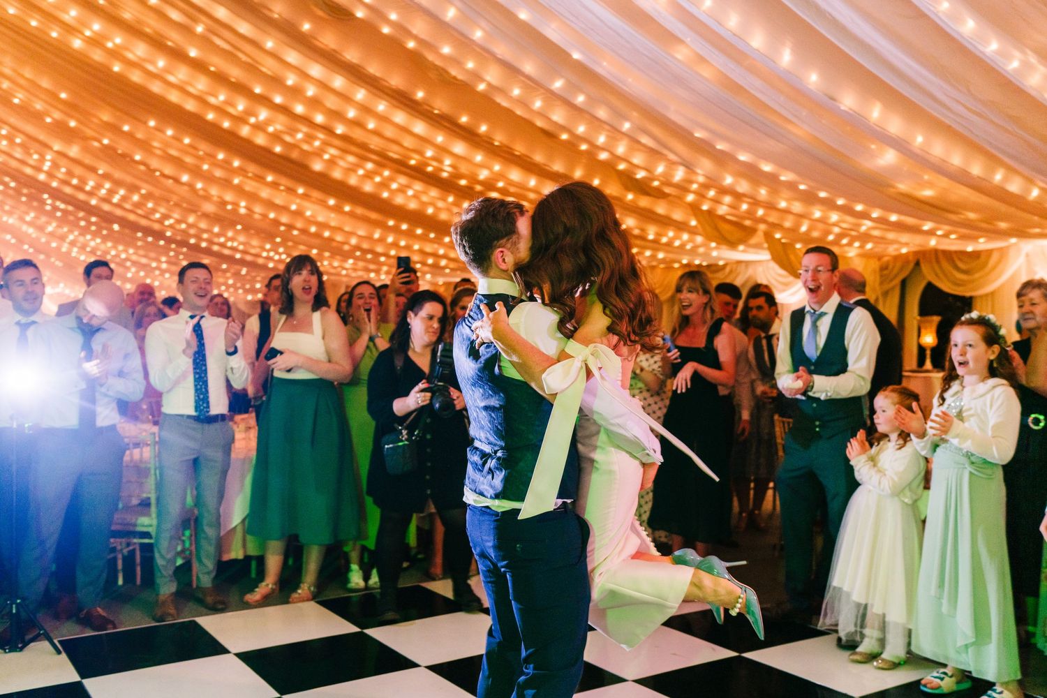 Castle Leslie Wedding Photographer Dublin Couples dance under twinkling string lights at an elegant tented wedding reception.