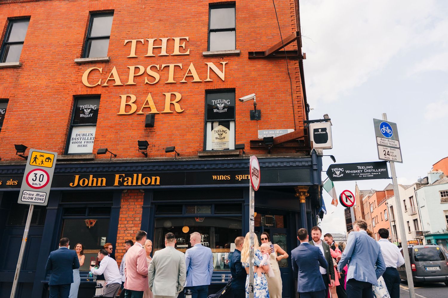 Red brick facade of The Capstan Bar with signage and windows. Same sex wedding PHOTOGRAPHER Dublin