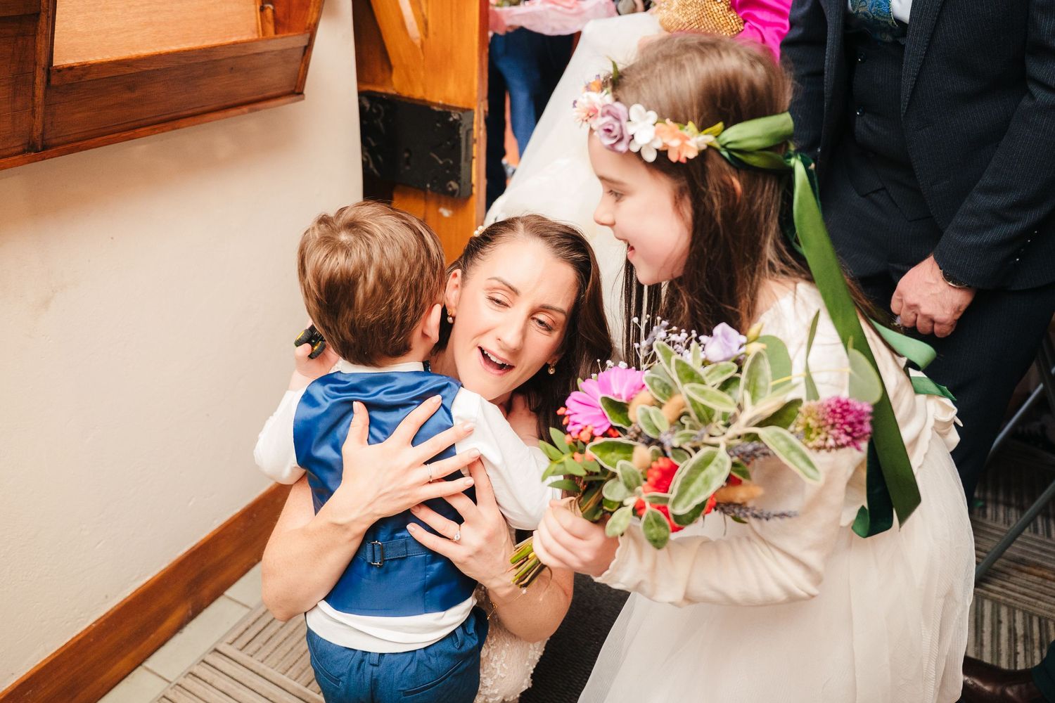 Series of candid wedding moments showing embraces and celebrations in an indoor setting.