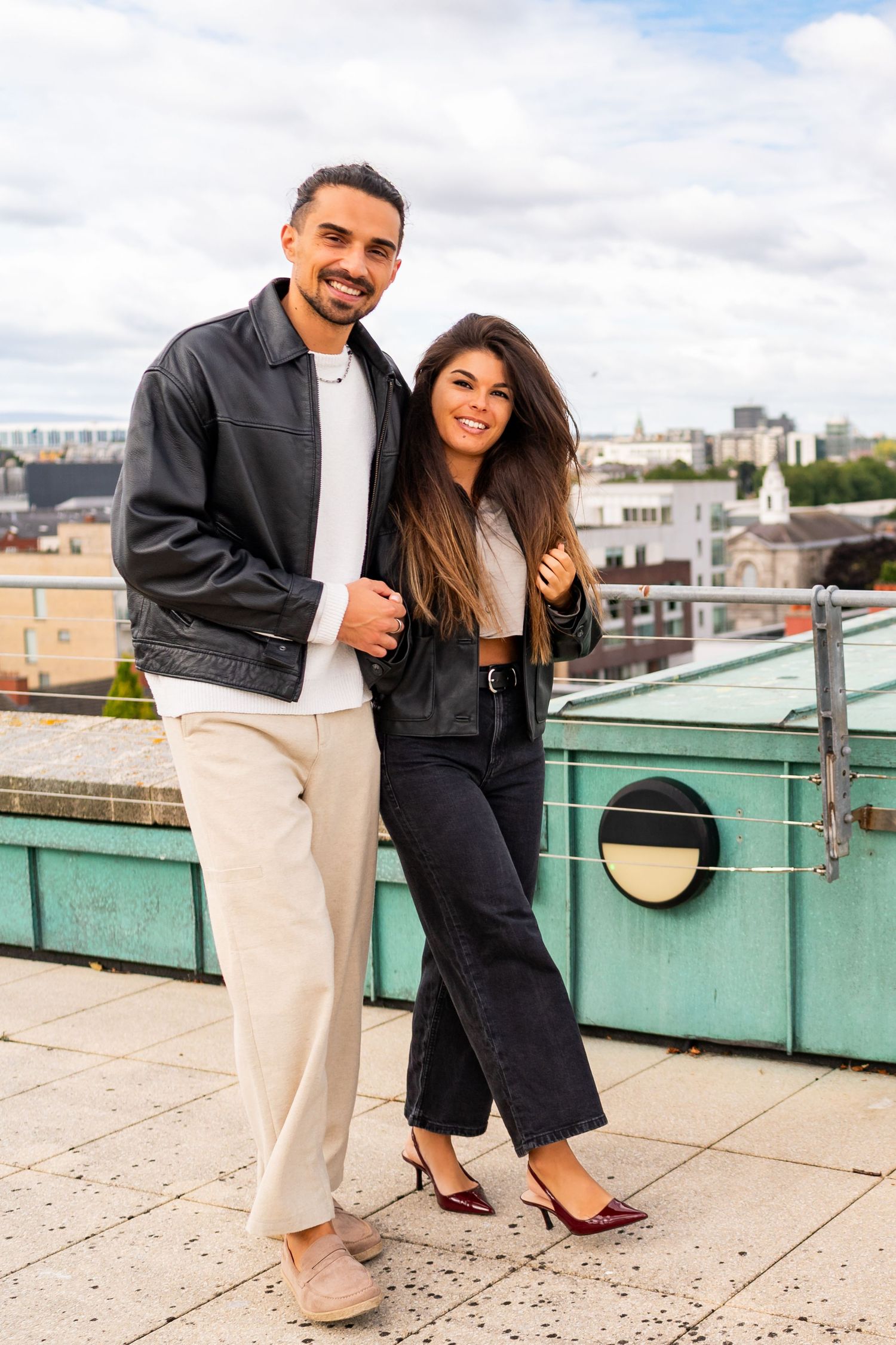 A couple shares candid moments on an urban rooftop with city views. Couple's Photoshoot PHOTOGRAPHER Dublin