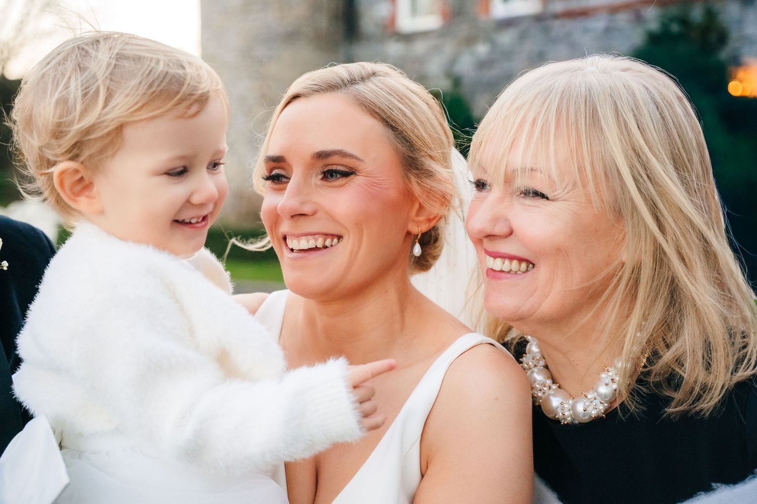 Wedding party members share joyful laughter and embraces during outdoor celebration. Ballymagarvey Wedding photographer