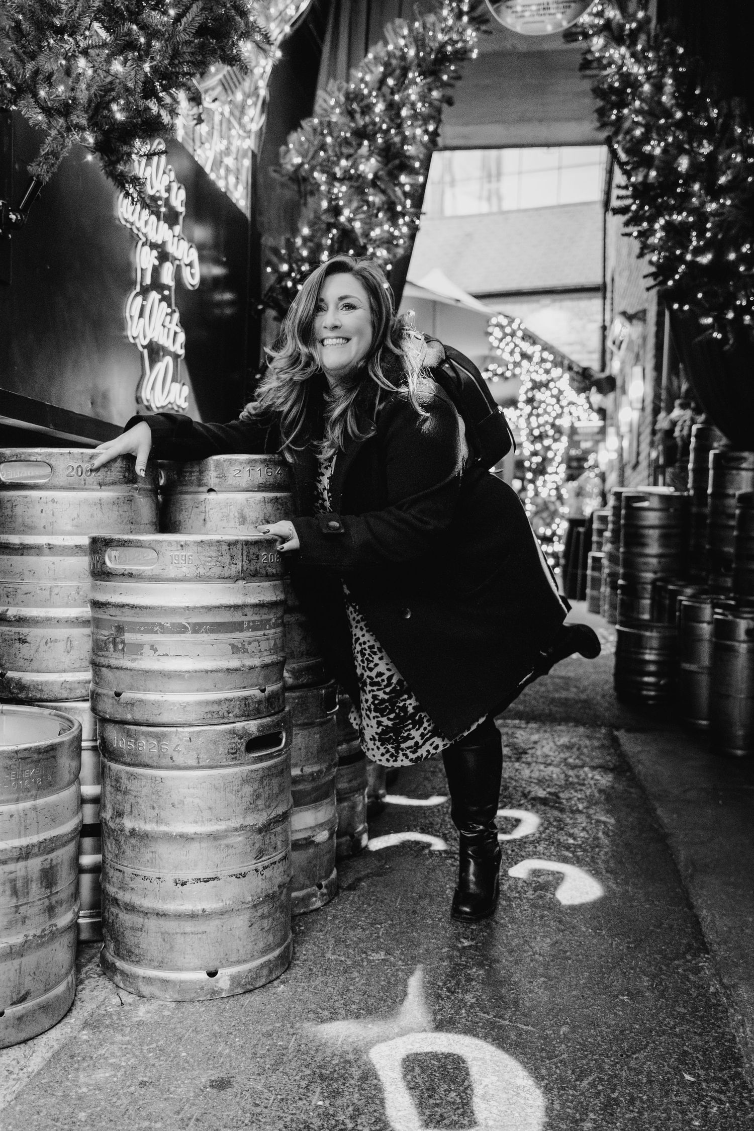 Black and white nighttime photos with decorative lights and beer kegs in background. family PHOTOGRAPHER Dublin