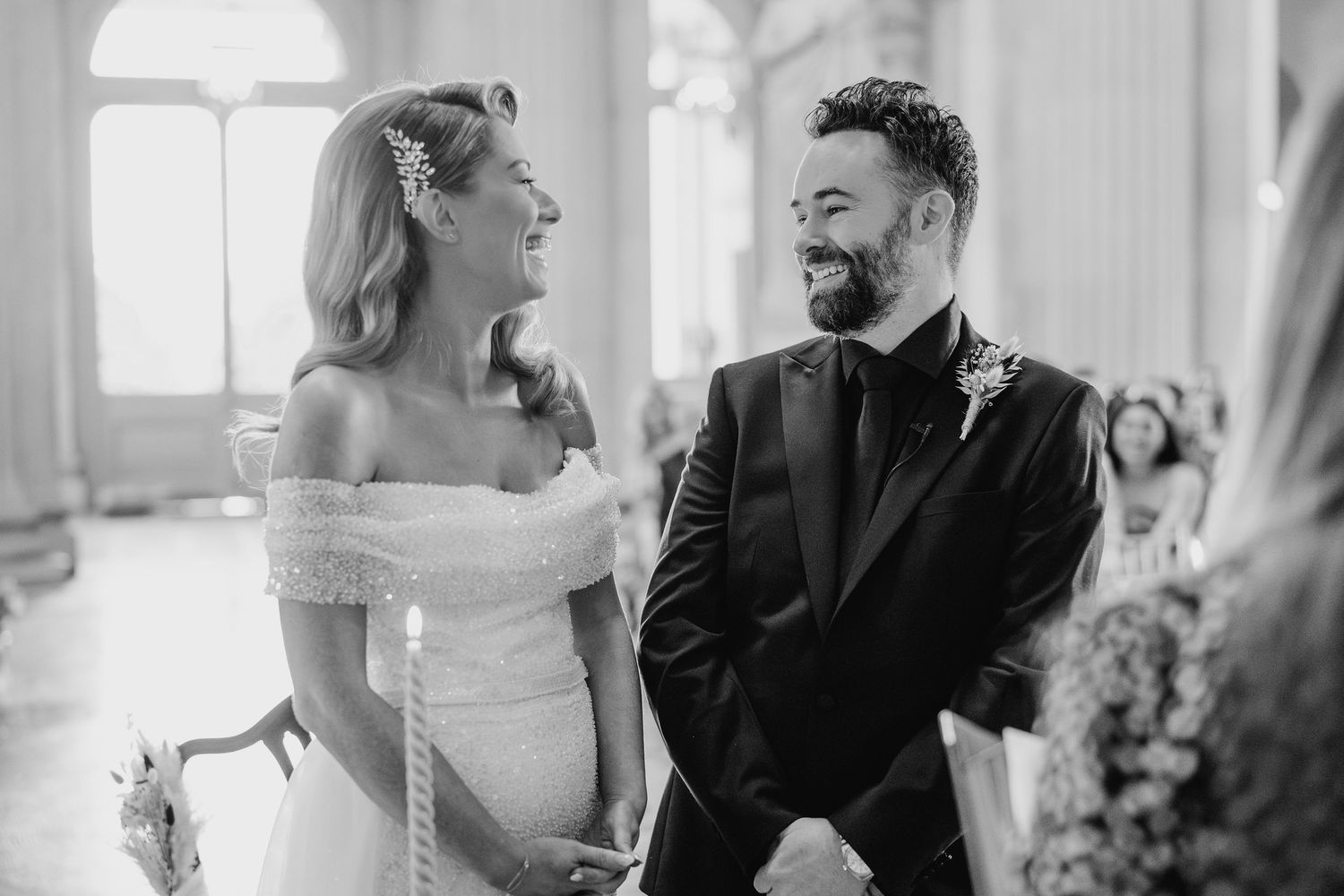 Black and white wedding ceremony photos showing intimate moments in an elegant indoor setting.  city hall dublin wedding photos