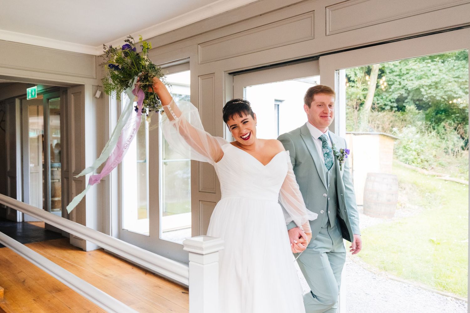 Millhouse slane wedding photographer dublin Light-filled indoor wedding venue with large windows and natural decor elements.