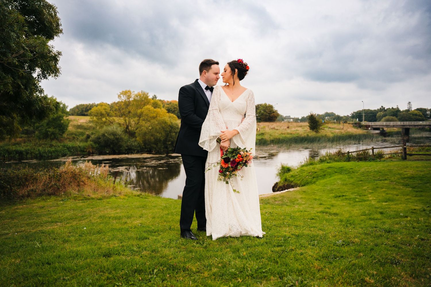 Scenic wedding photos taken near a lake and castle showing panoramic views of green countryside. Wedding Photography Trim Castle Ireland
