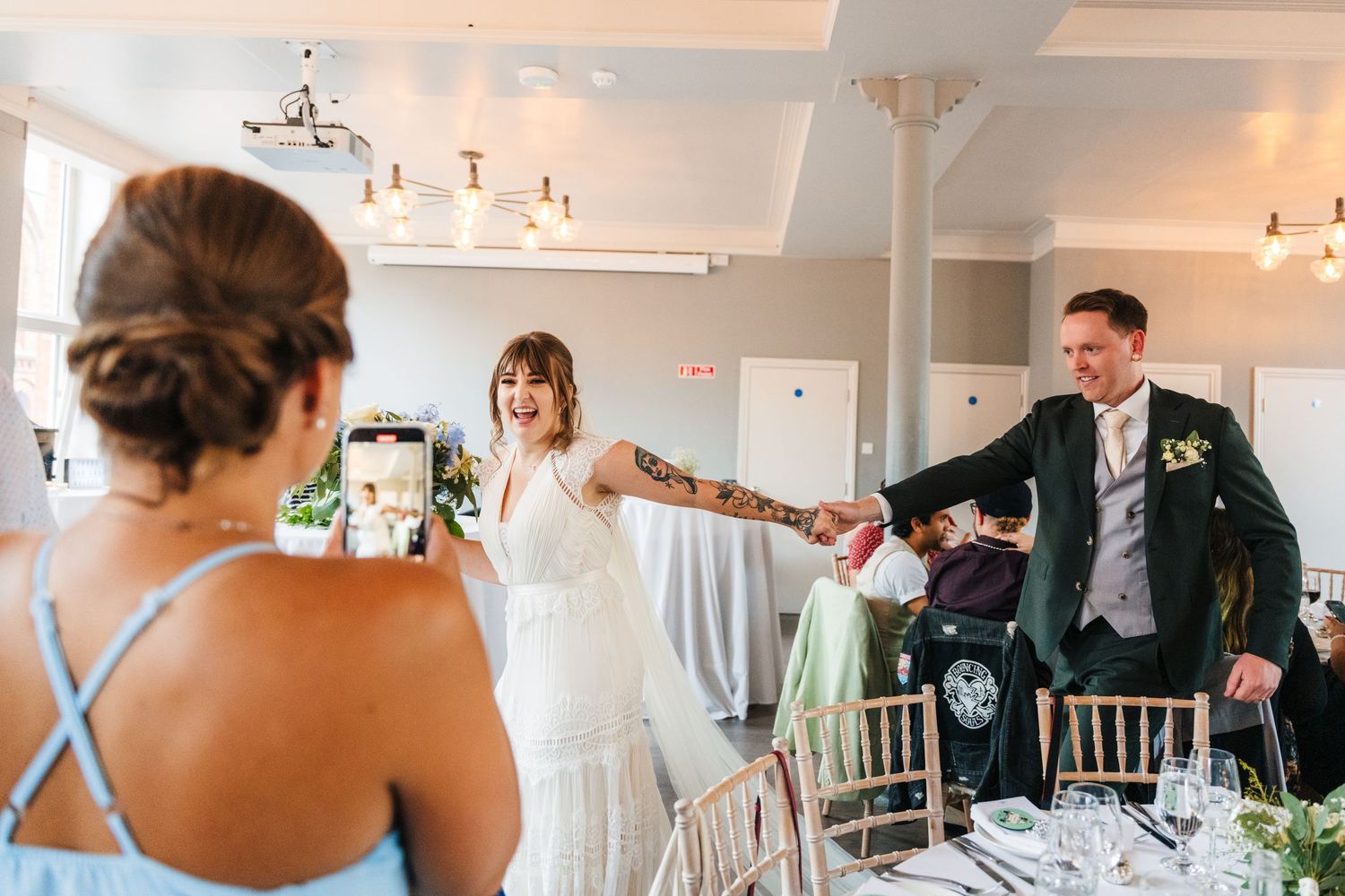 Dancing and celebration during wedding reception in bright white venue space. PHOTOGRAPHER Dublin Ireland Wedding