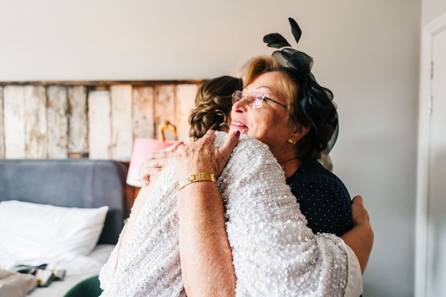 A tender moment of embrace captured in a bedroom setting. House Dublin Wedding Photographer
