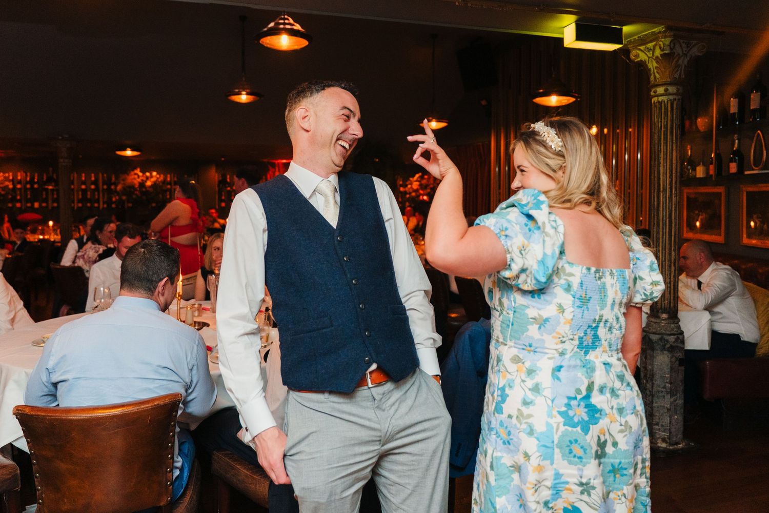 Wedding guests dancing and celebrating in a dimly lit venue. Marco Pierre Dublin Wedding Photographer