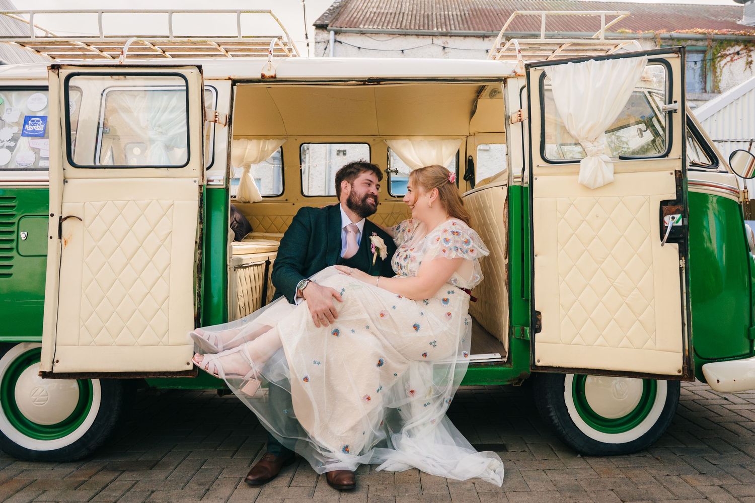 Newlyweds share an intimate moment inside a vintage mint green and white camper van. . Village Barn Tyrrellspass wedding photographer Irelan