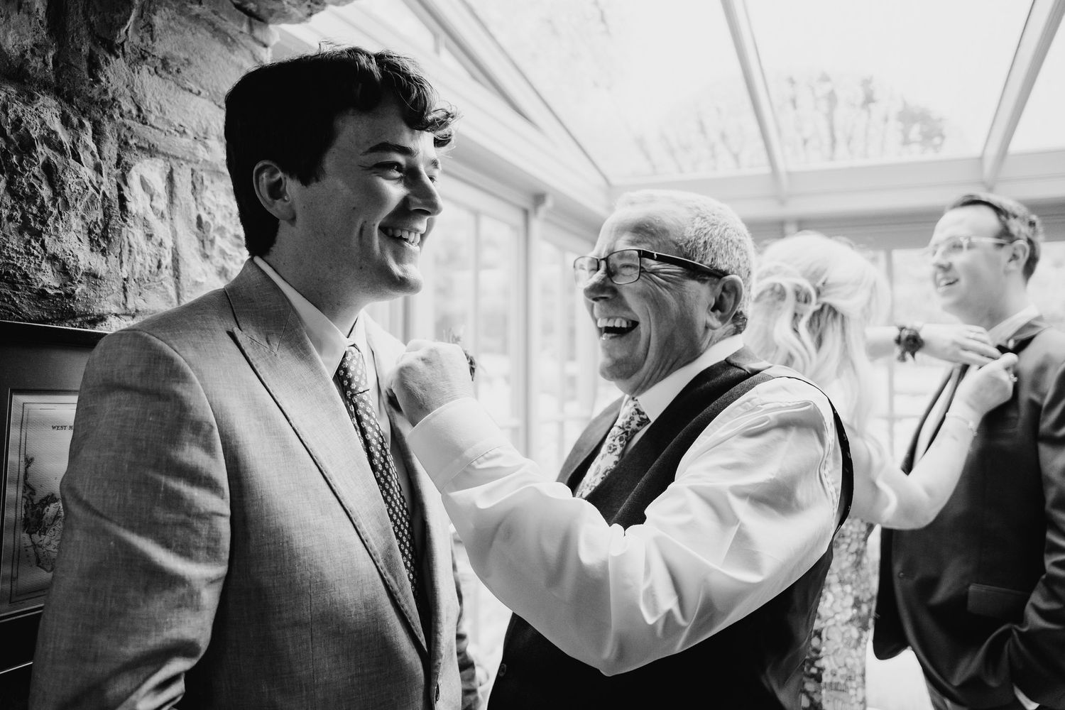 Black and white candid photos show joyful moments of laughter and conversation at a gathering. Wedding photographer Dublin