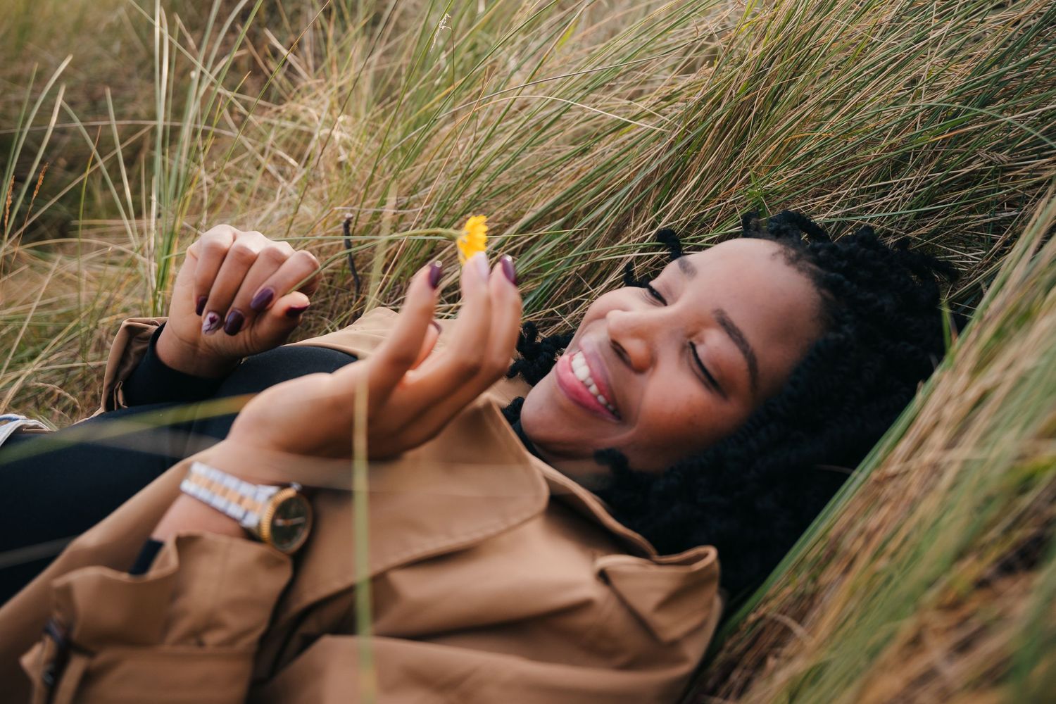 Candid lifestyle photo in tall grass meadow wearing casual autumn attire. Dublin professional headshots photographer