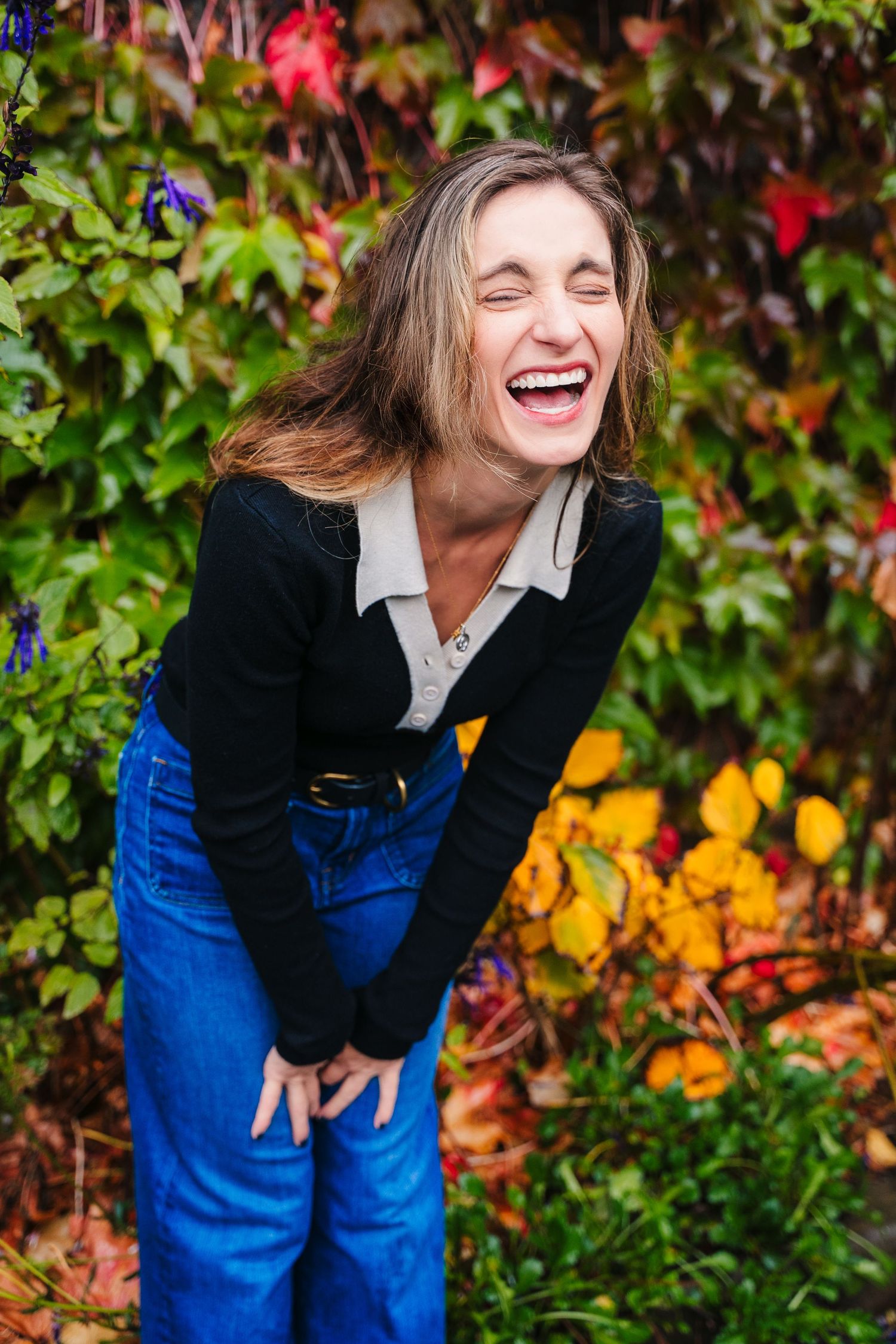 Casual autumn fashion shoot with blue jeans against colorful fall foliage background. professional headshots dublin photographer
