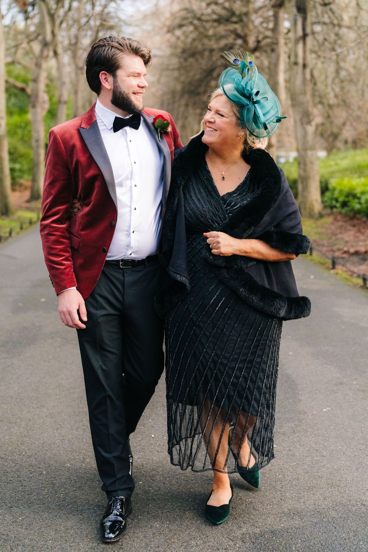 Couple dancing on path, one wearing burgundy tuxedo and other in black fringe dress. Stephens green club dublin Wedding photographer