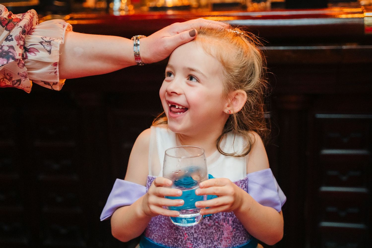 Child joyfully dancing with adults during a celebratory event. Marco Pierre Dublin Wedding Photographer