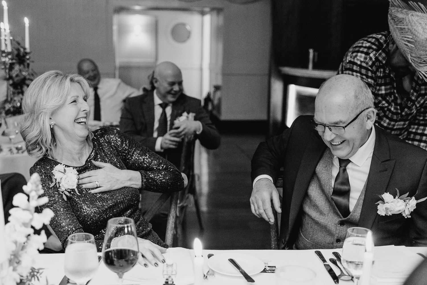 Black and white candid shots of wedding guests during dinner conversation.  Virginia Park Lodge Wedding Photographer Cavan Dublin Ireland